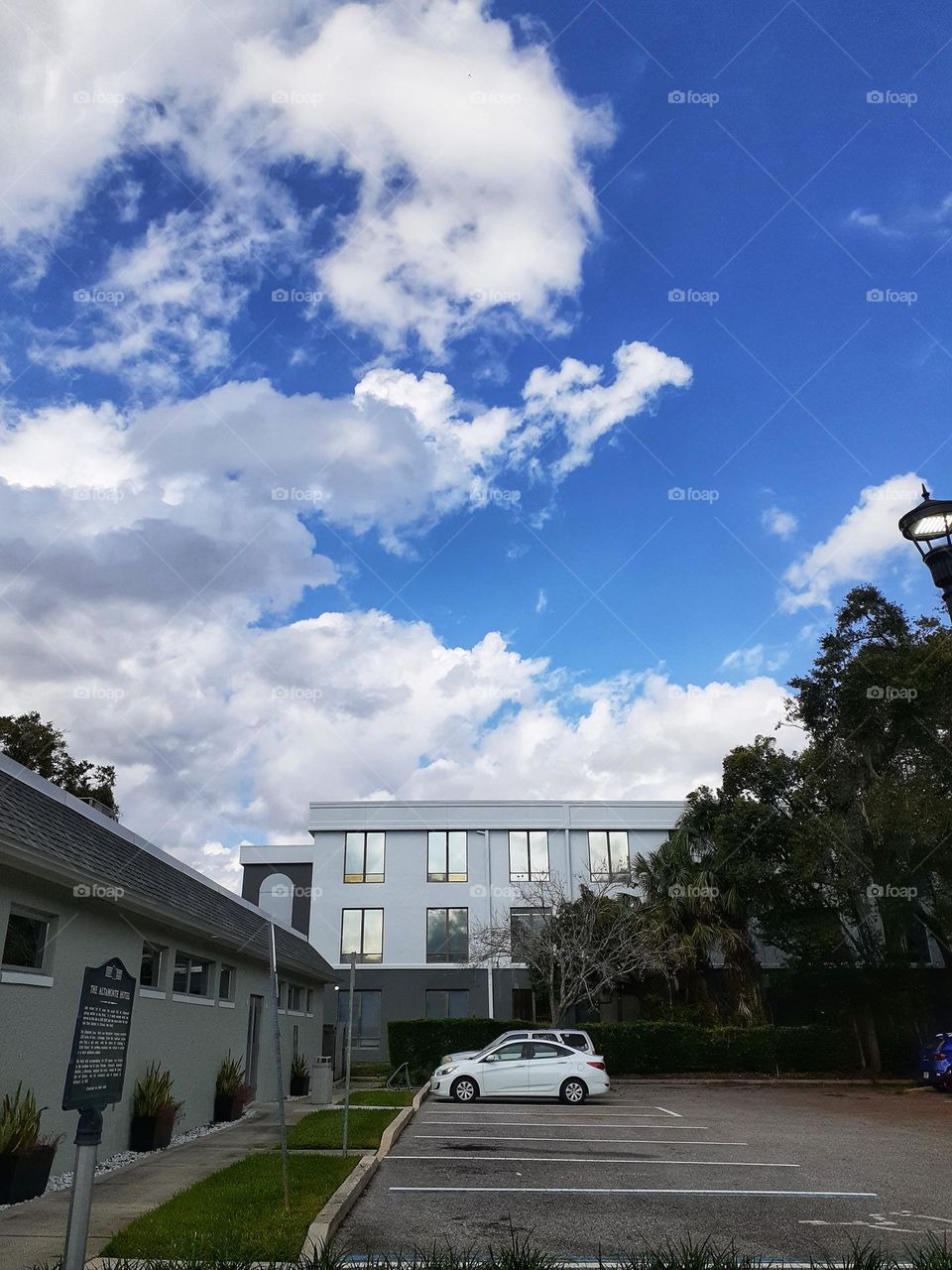 Beautiful fluffy white clouds in a blue sky outside the Altamonte Springs City Library.