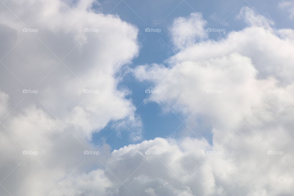 blue sky with white puffy soft clouds 