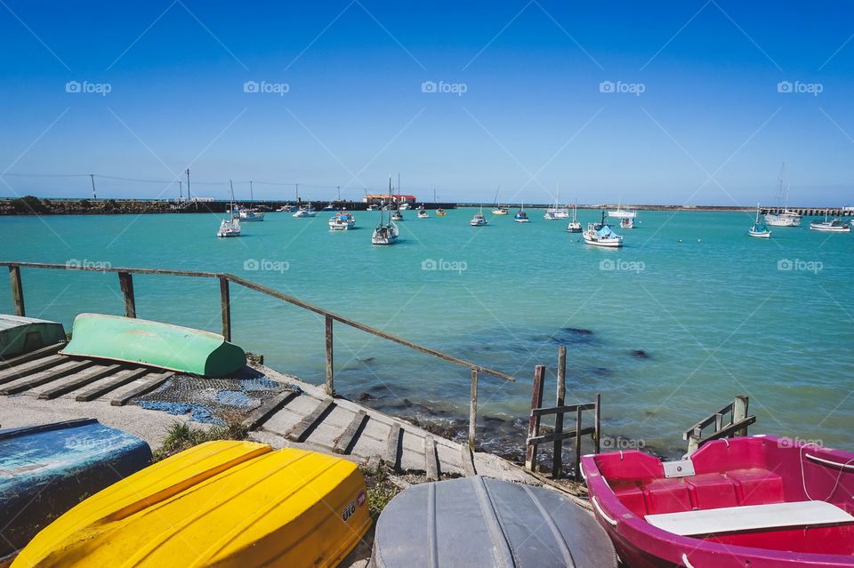 Bright boats and blue water at the Oamaru Harbour, New Zealand 