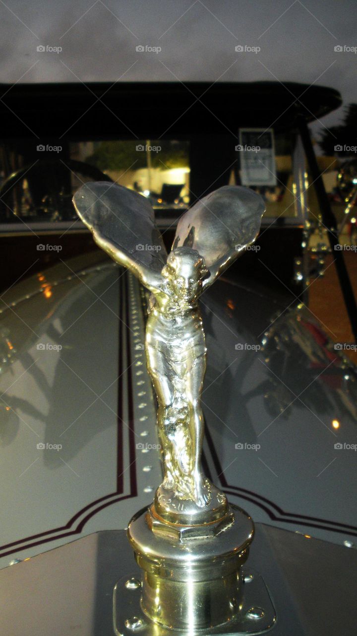 ornate hood ornament closeup at classic car auction