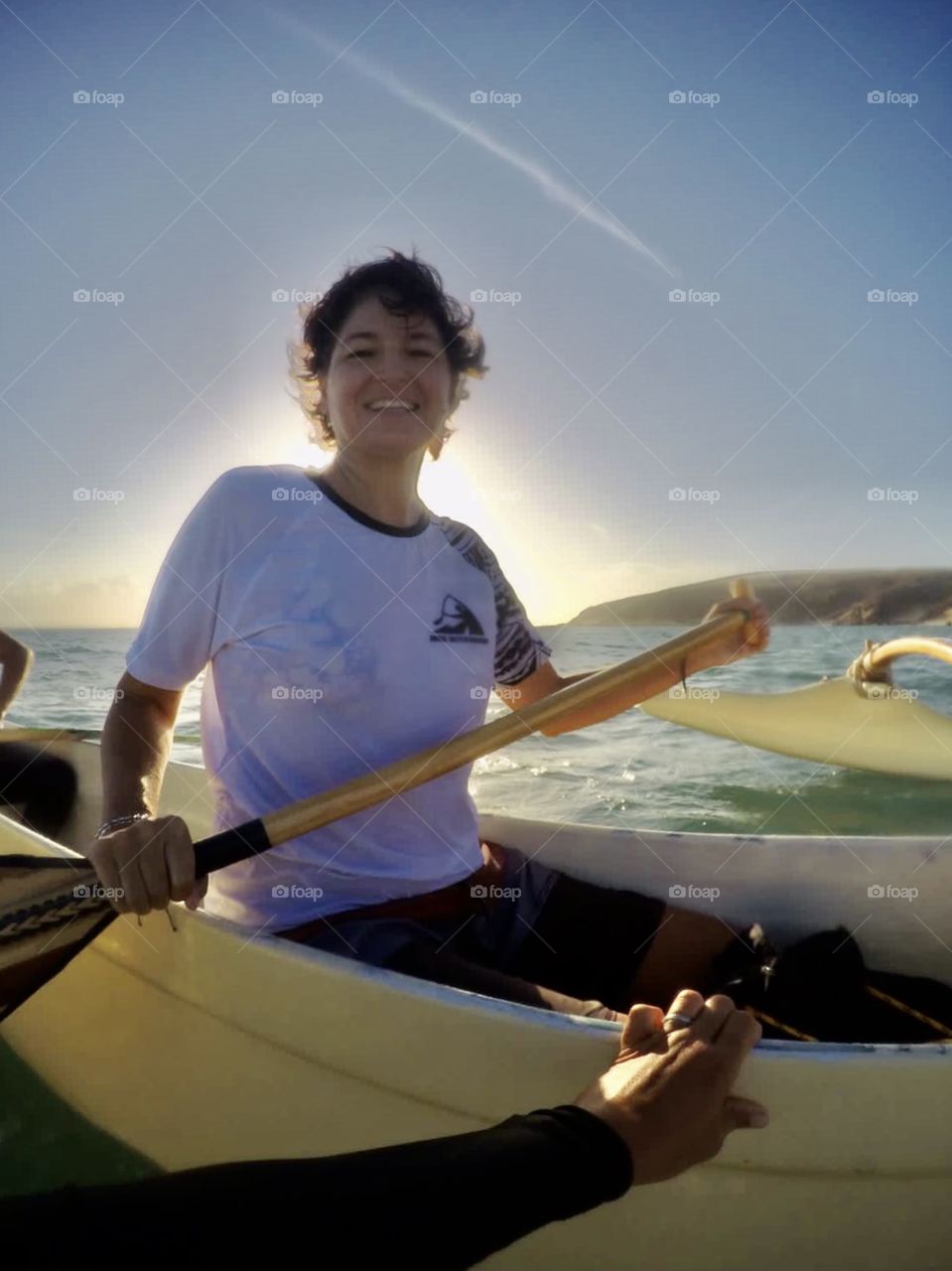 Woman with oak on kayak in the sea 