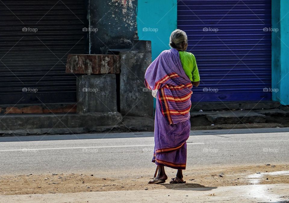 Old women waiting to cross the road
