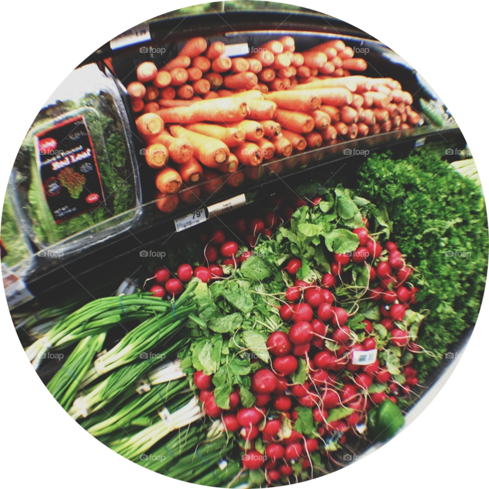 Circular cutout of veggie isle in grocery store. 