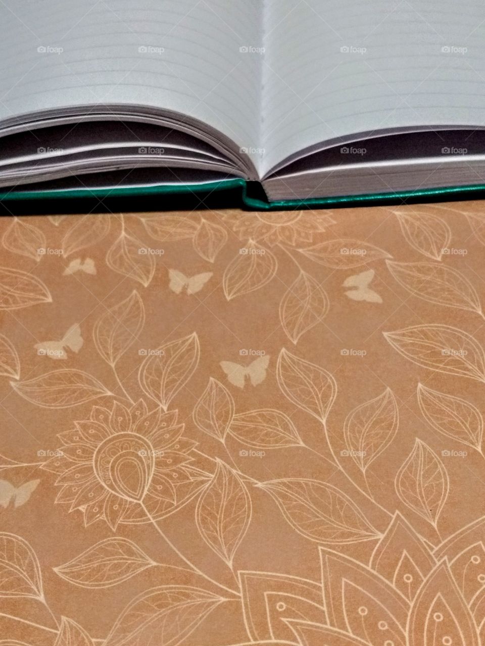 green open diary/journal on pink patterned background