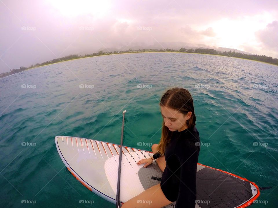 Siting on SUP board in Hawaii
