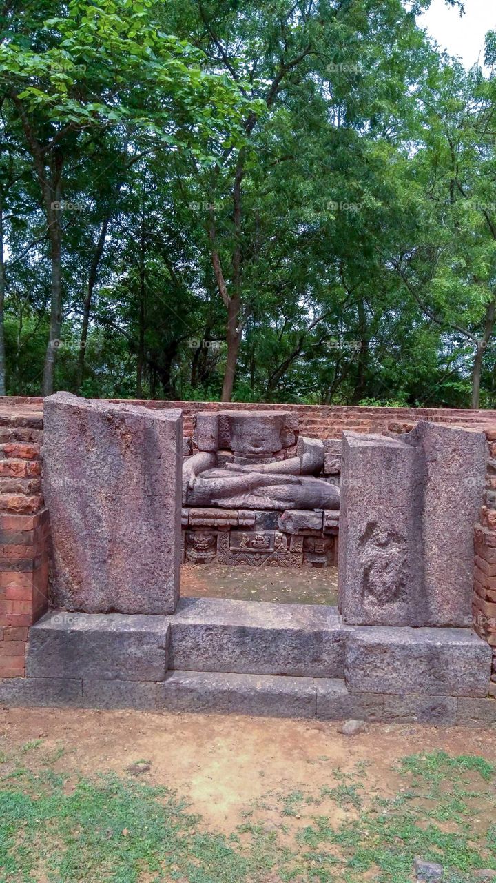 a old stone statue of budhha Deb