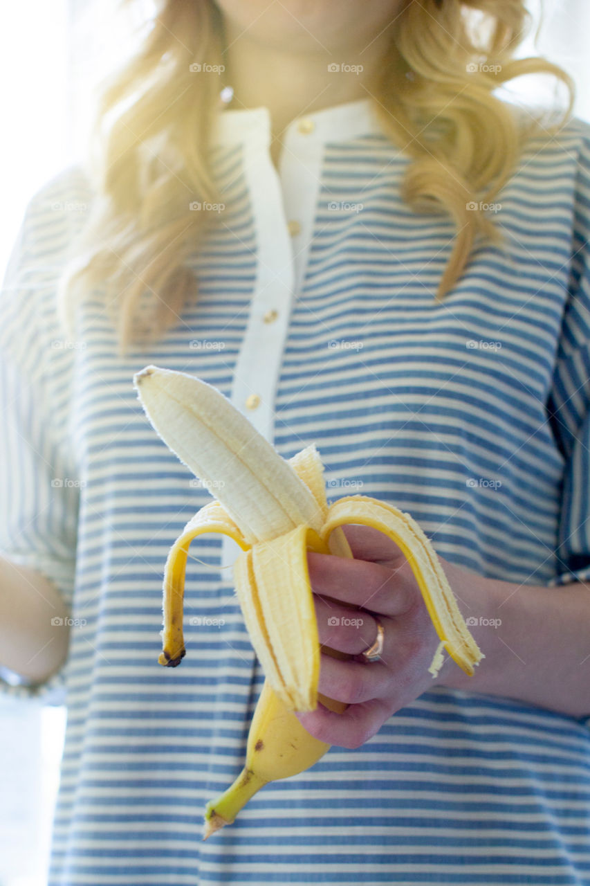 Young woman with a banana in her hand