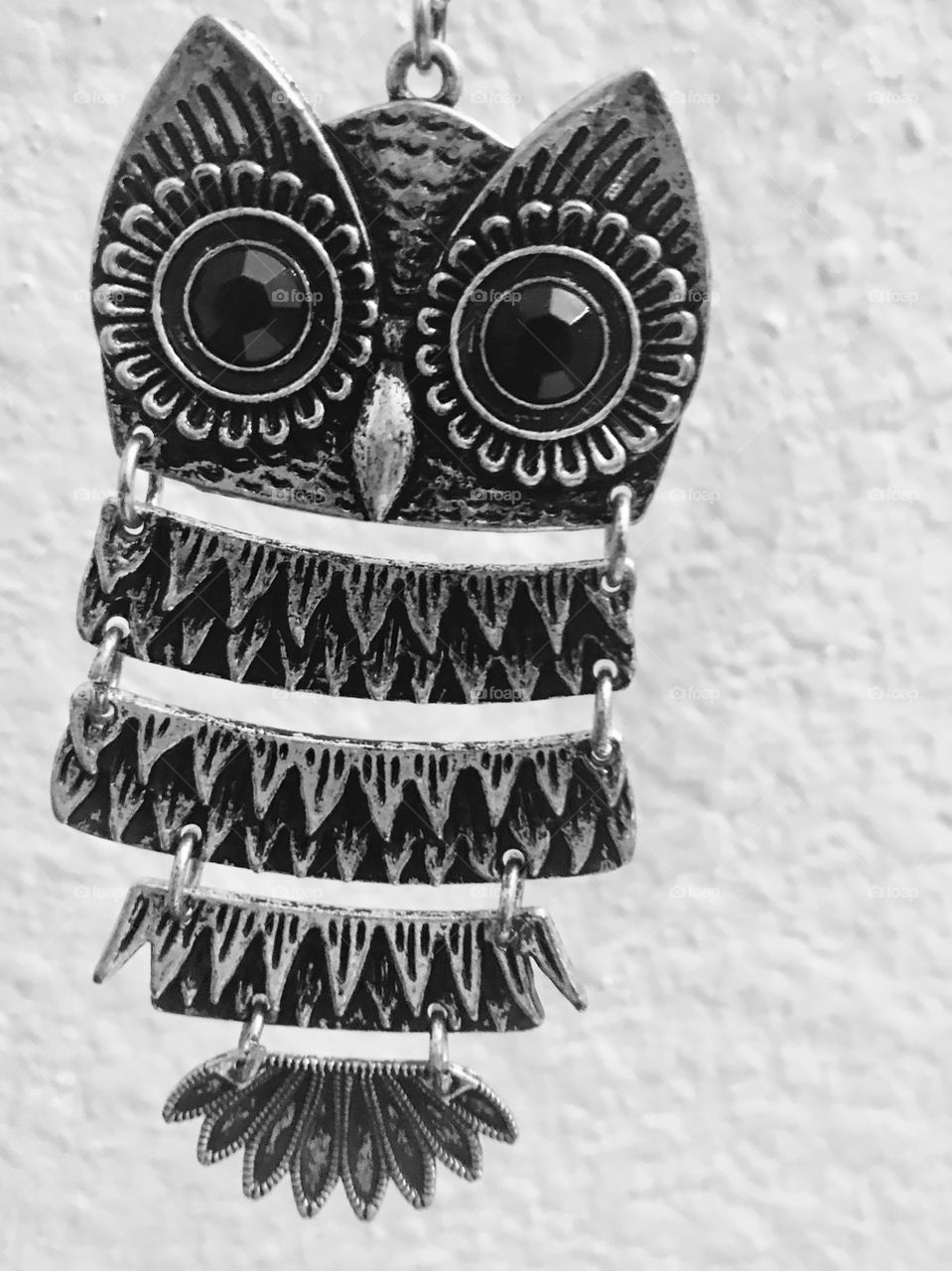 An owl necklace piece.