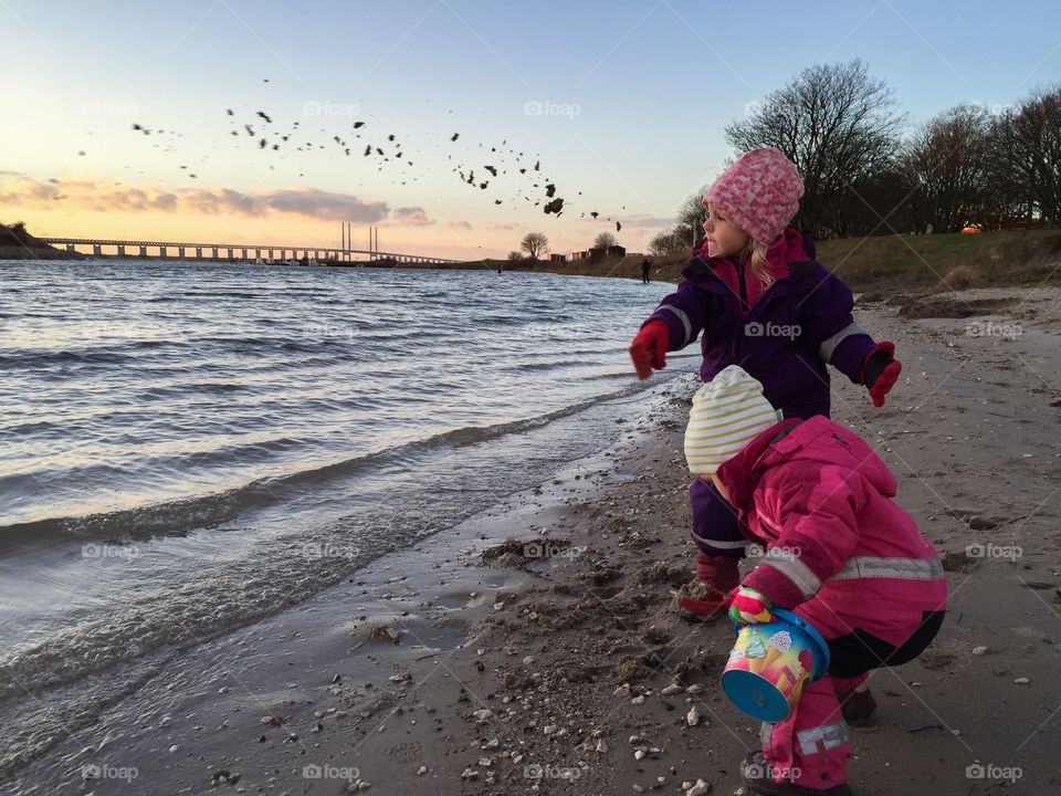 Two sibling playing on beach