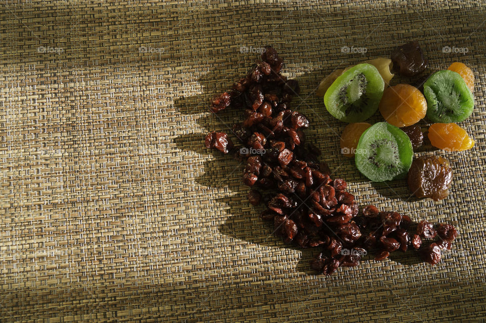 dry fruits cranberry and kiwis in a rustic fabric