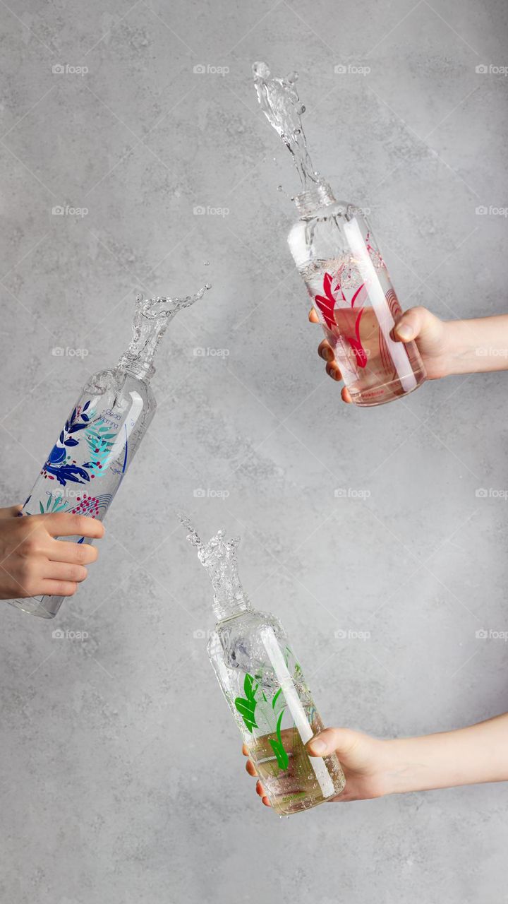 Three water bottles with water splash 