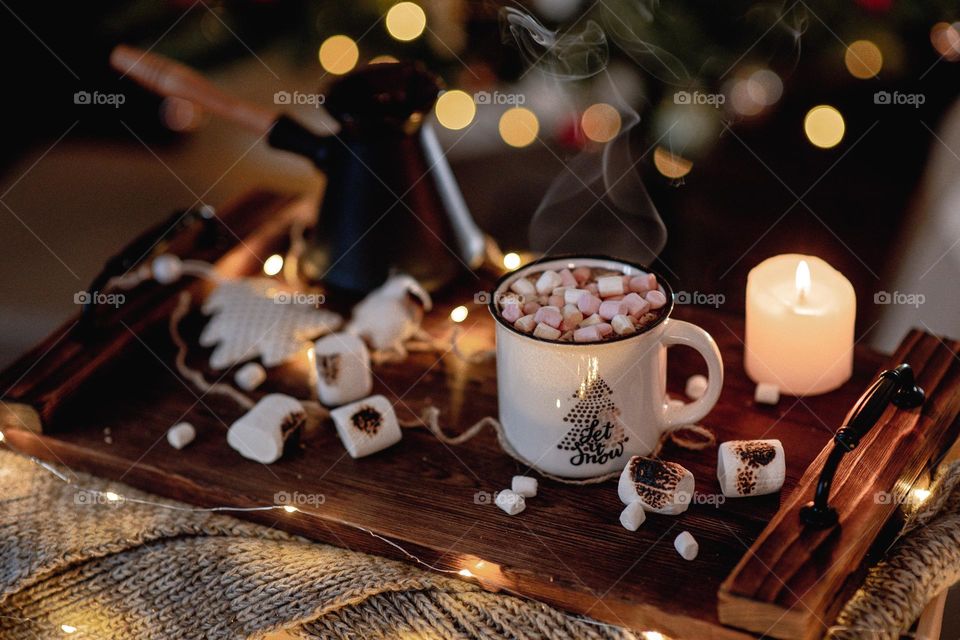 Freshly brewed coffee in white mug. Christmas mood. Hot beverages.  Hot chocolate with marshmallow
