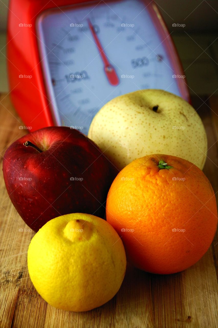 fresh fruits and a weighing scale