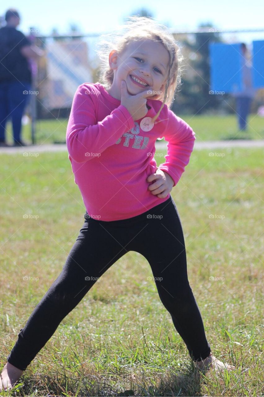 Smiling girl posing on grass