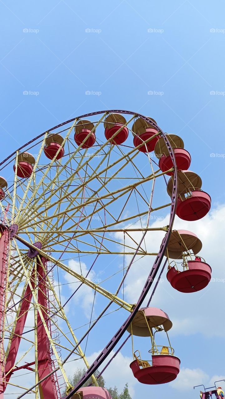 Amusement park, wheel, circle, sky, spin, red, blue, clouds