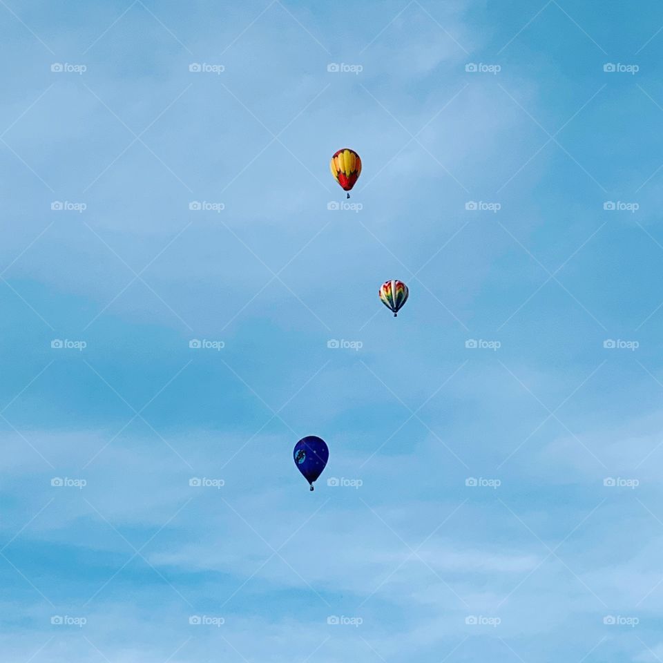Three colorful hot air balloons in sky 
