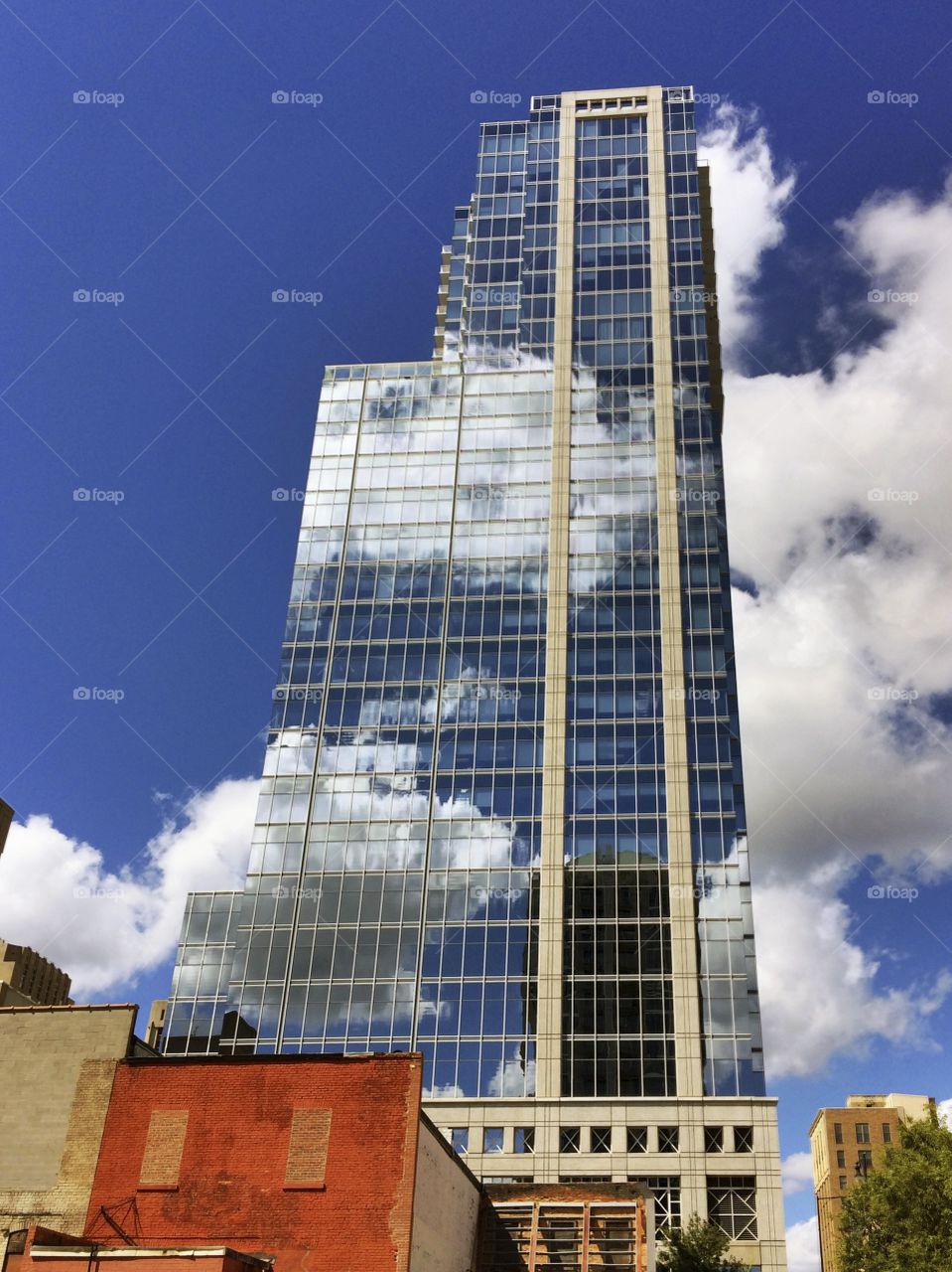 Clouds & Building. I noticed that the clouds in the sky were lining up beautifully with the clouds in the reflection on this building. 