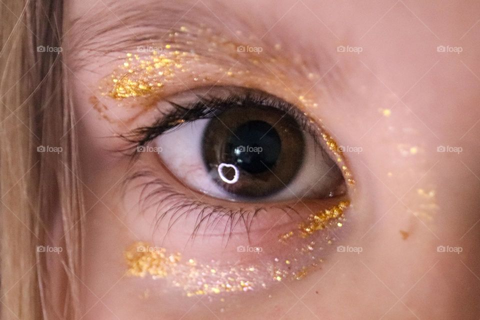 A child with glittery make-up