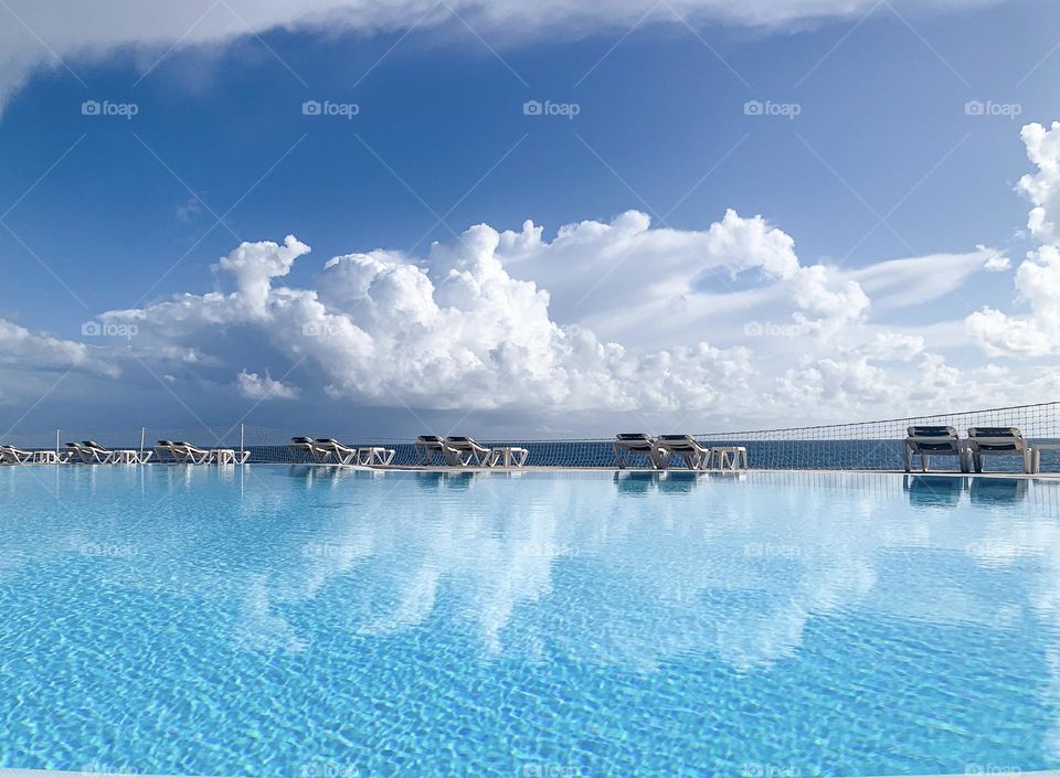 Clouds over water surface, blue sky, water pool