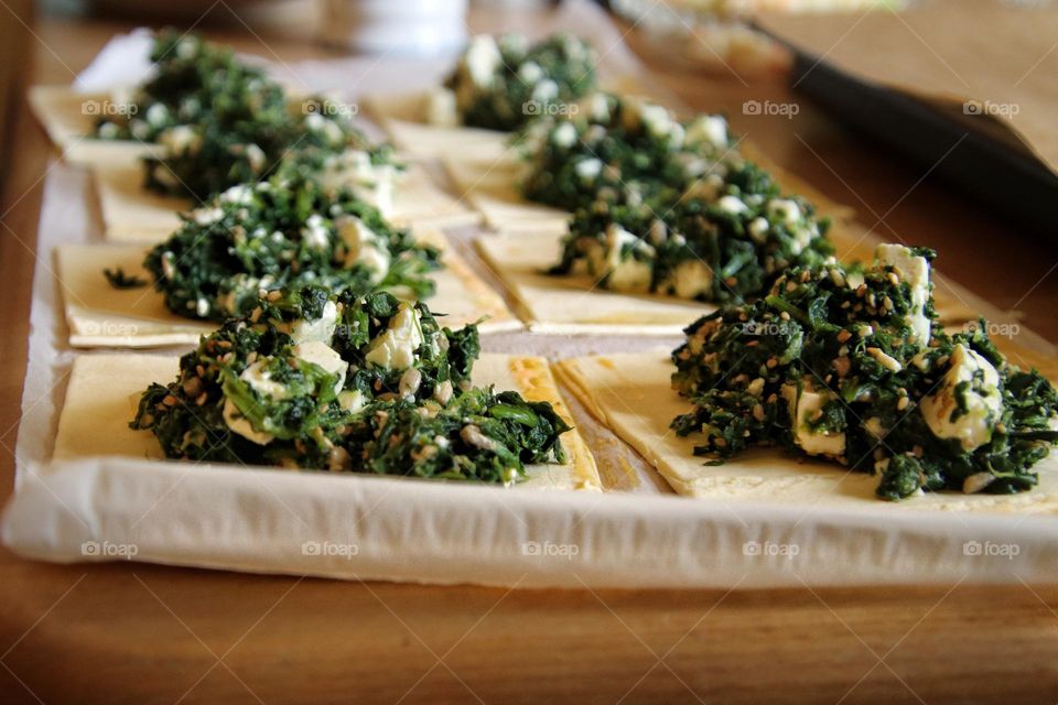 Close-up of a spinach and feta filling on puff pastry