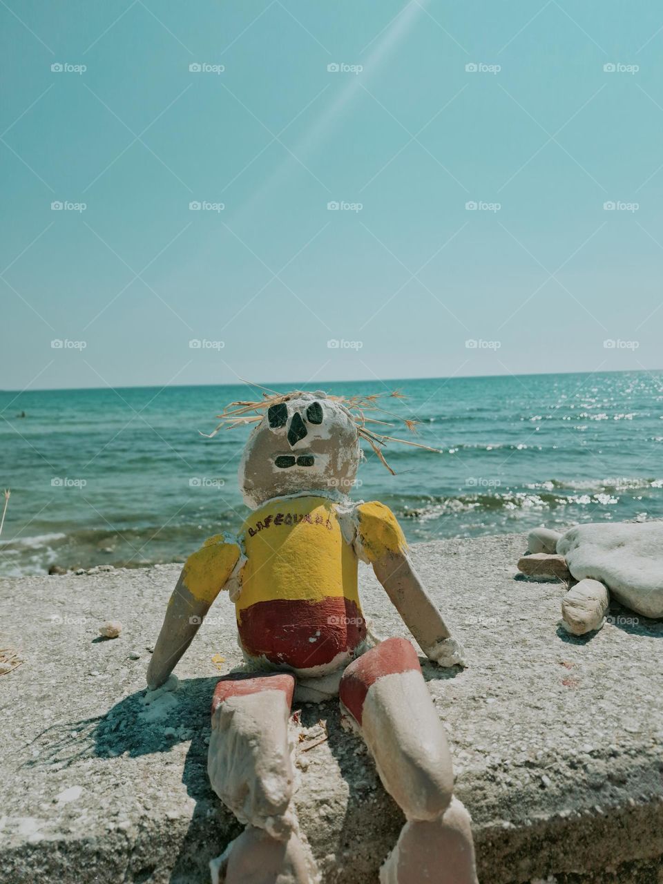 lifeguard doll made of stones