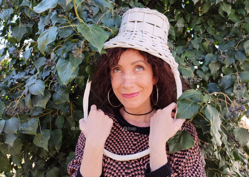 Funny Portrait of Young Woman Posing With Basket on Head, Smiling with Happy Face