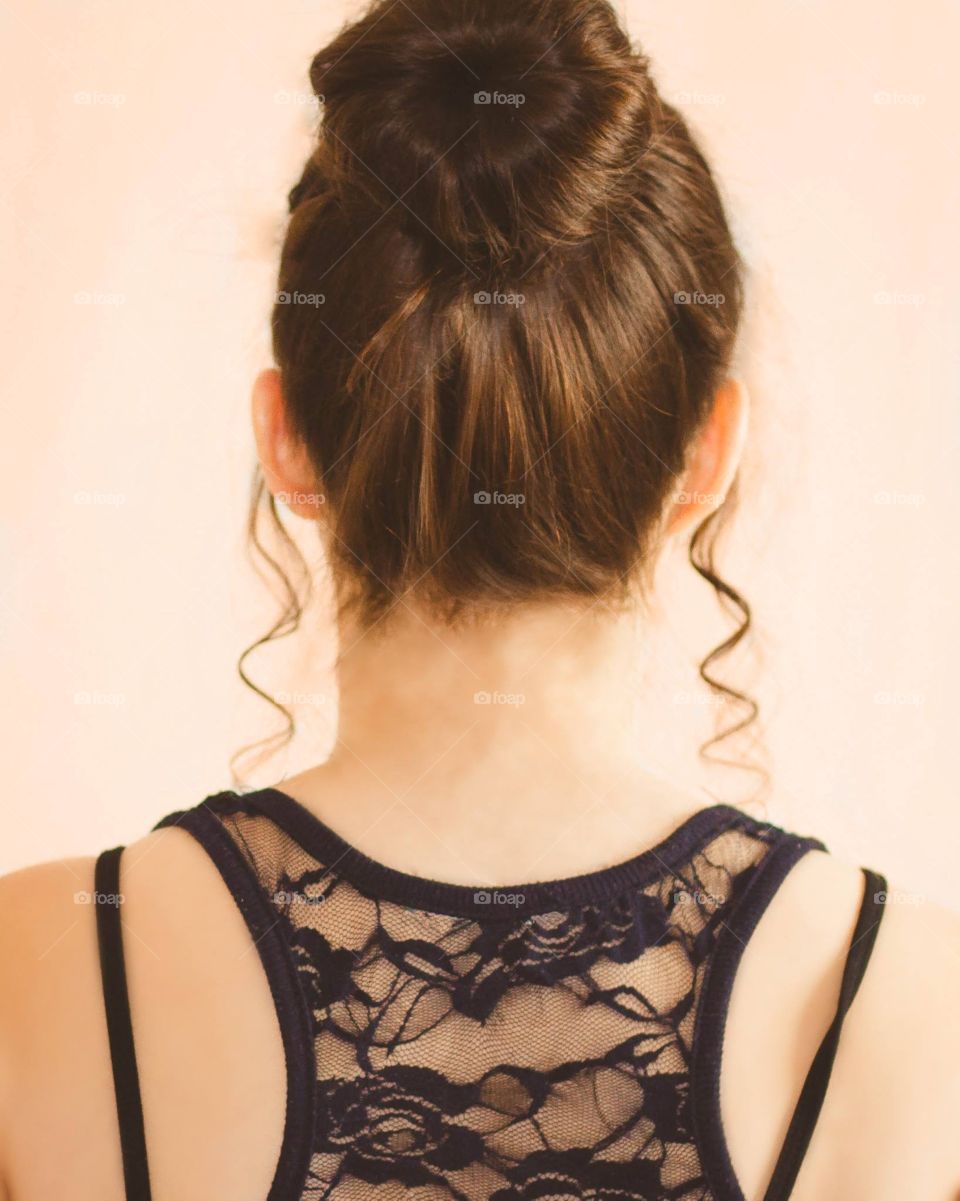 A classical fashion image of the back of a woman's bun 