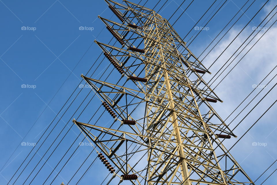 power line. Looking up electric transmission tower