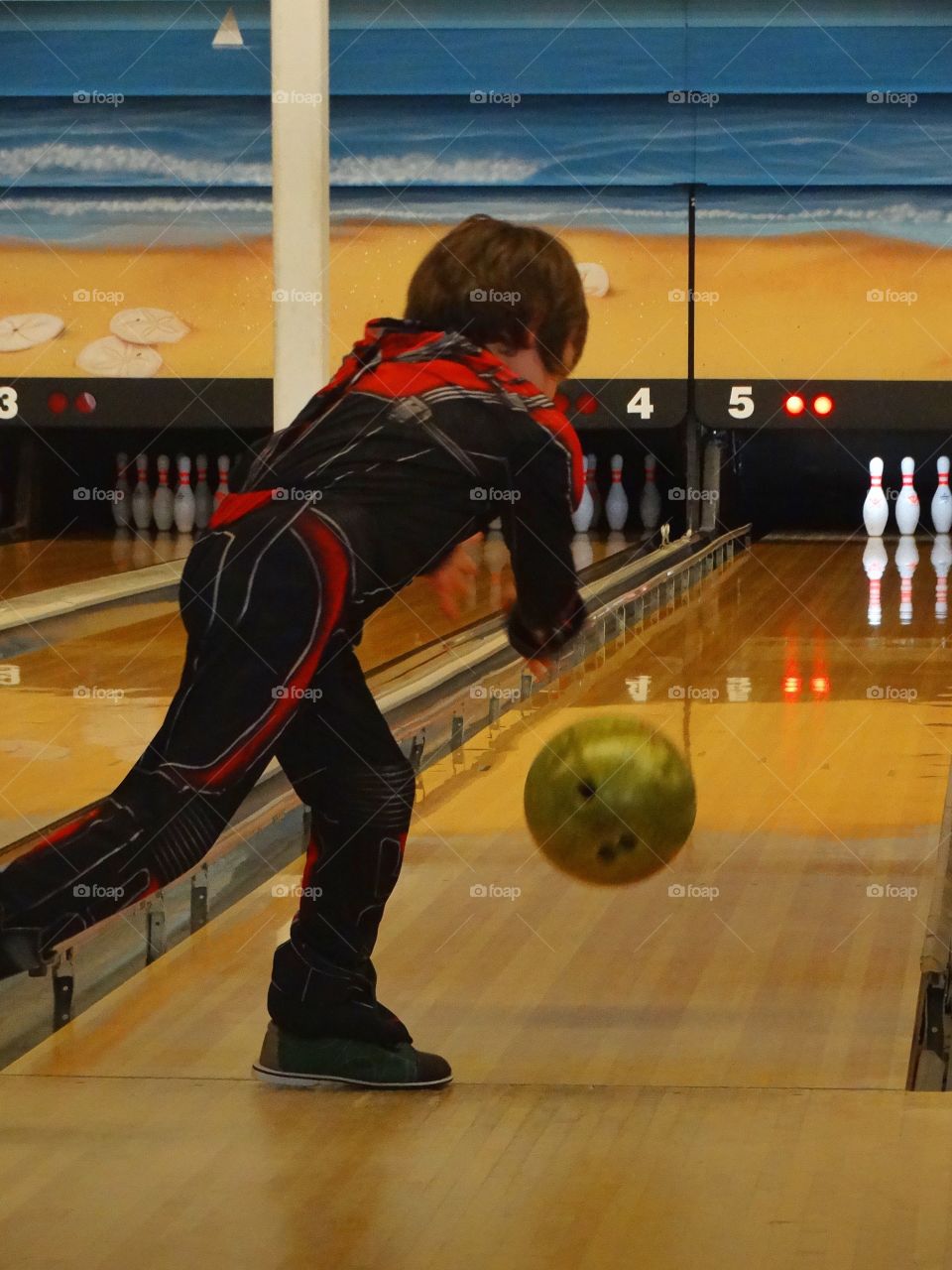 Boy Tossing A Bowling Ball