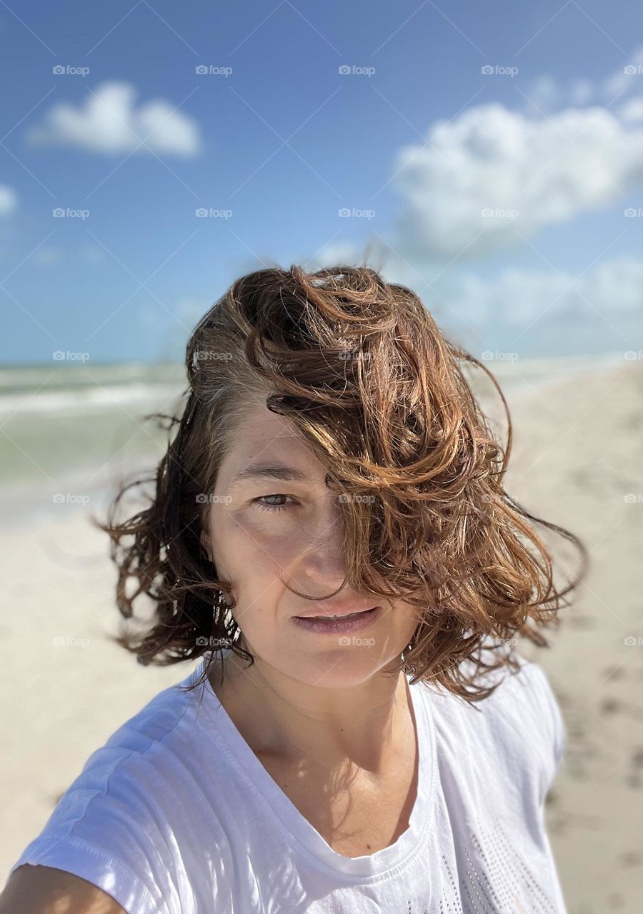 Woman portrait selfie against beach 