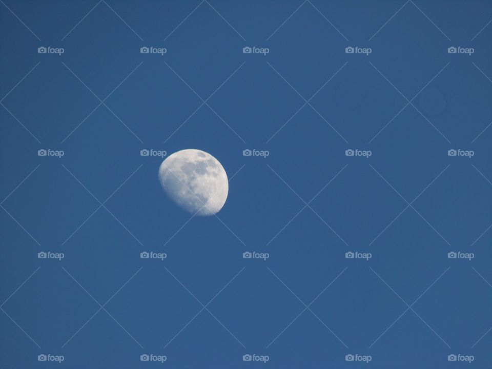 A moon in a blue sky
