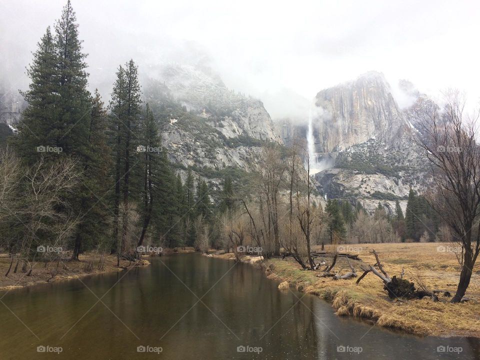 Autumn view of the river close to the huge rock