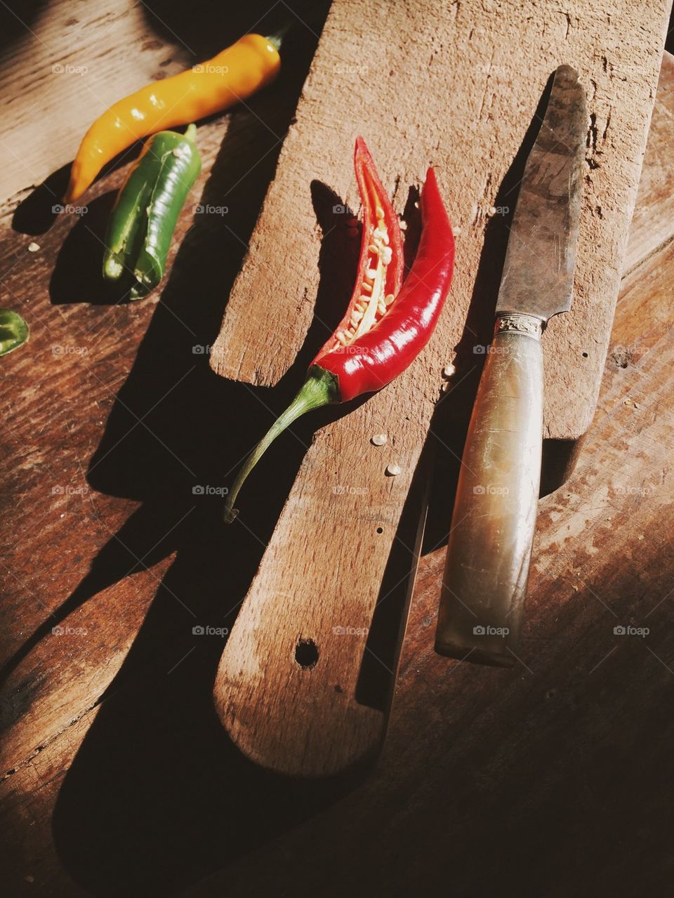 Chili pepper on old wooden cutting board