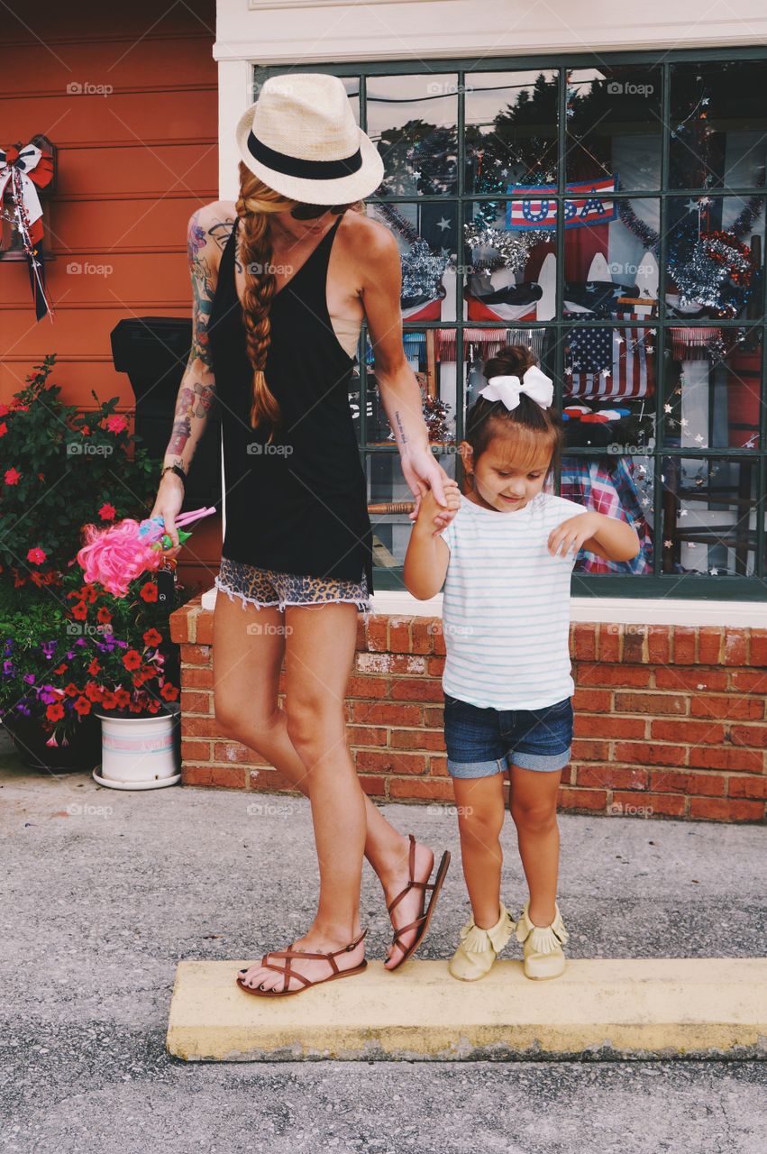 Mother with daughter standing outdoors