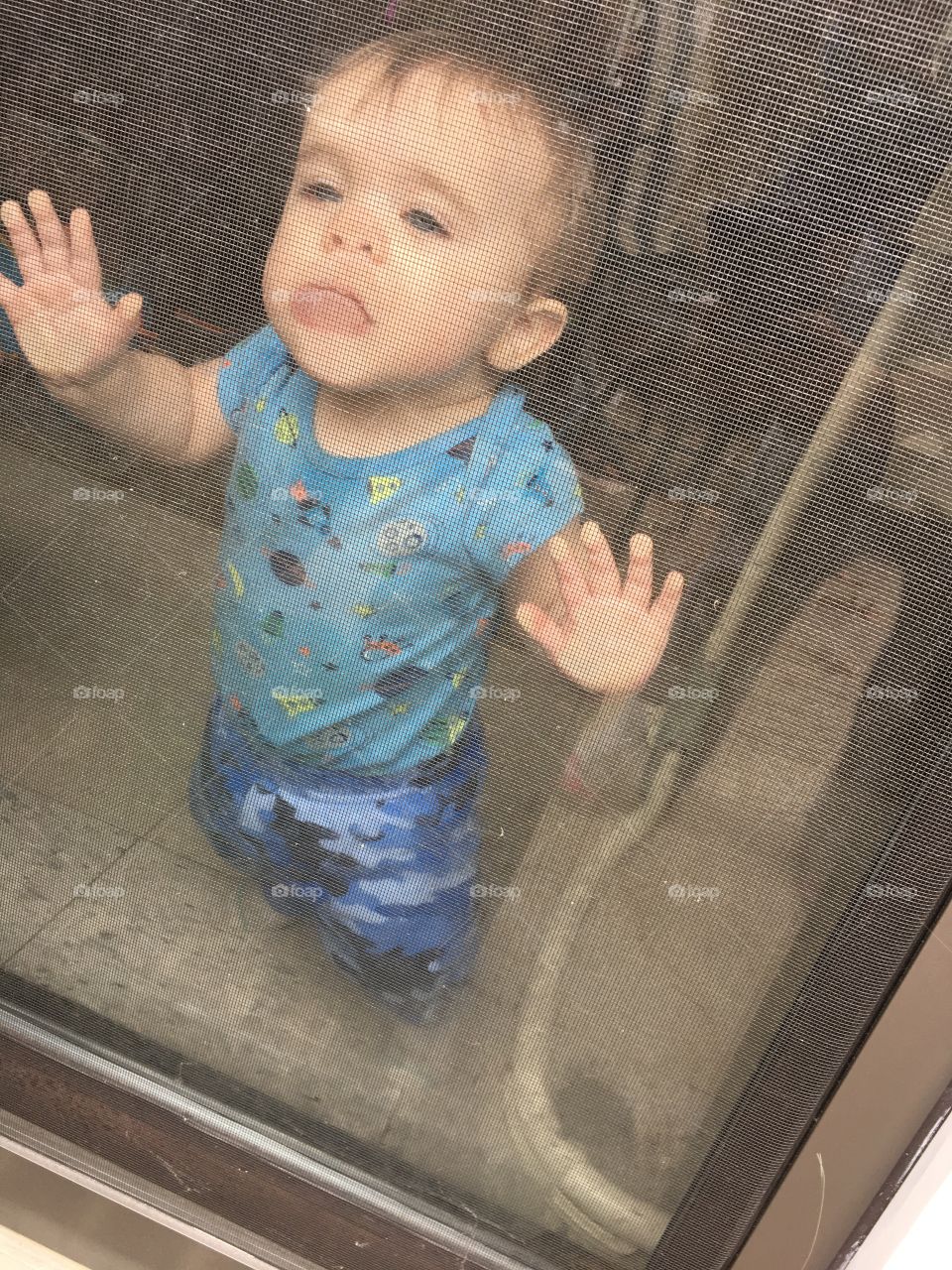 My son making funny faces through the window while I was outside.  
