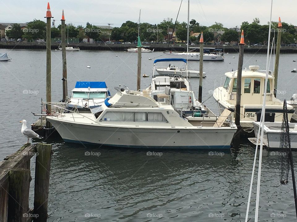 Boats on the East River at Newtown Creek in Long Island City, Queens, New York on an overcast late afternoon in 2018 photographed from the shore. Hypnotic Productions