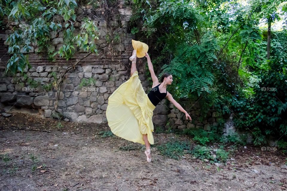 Young Female Ballerina Dancing Outside in Nature