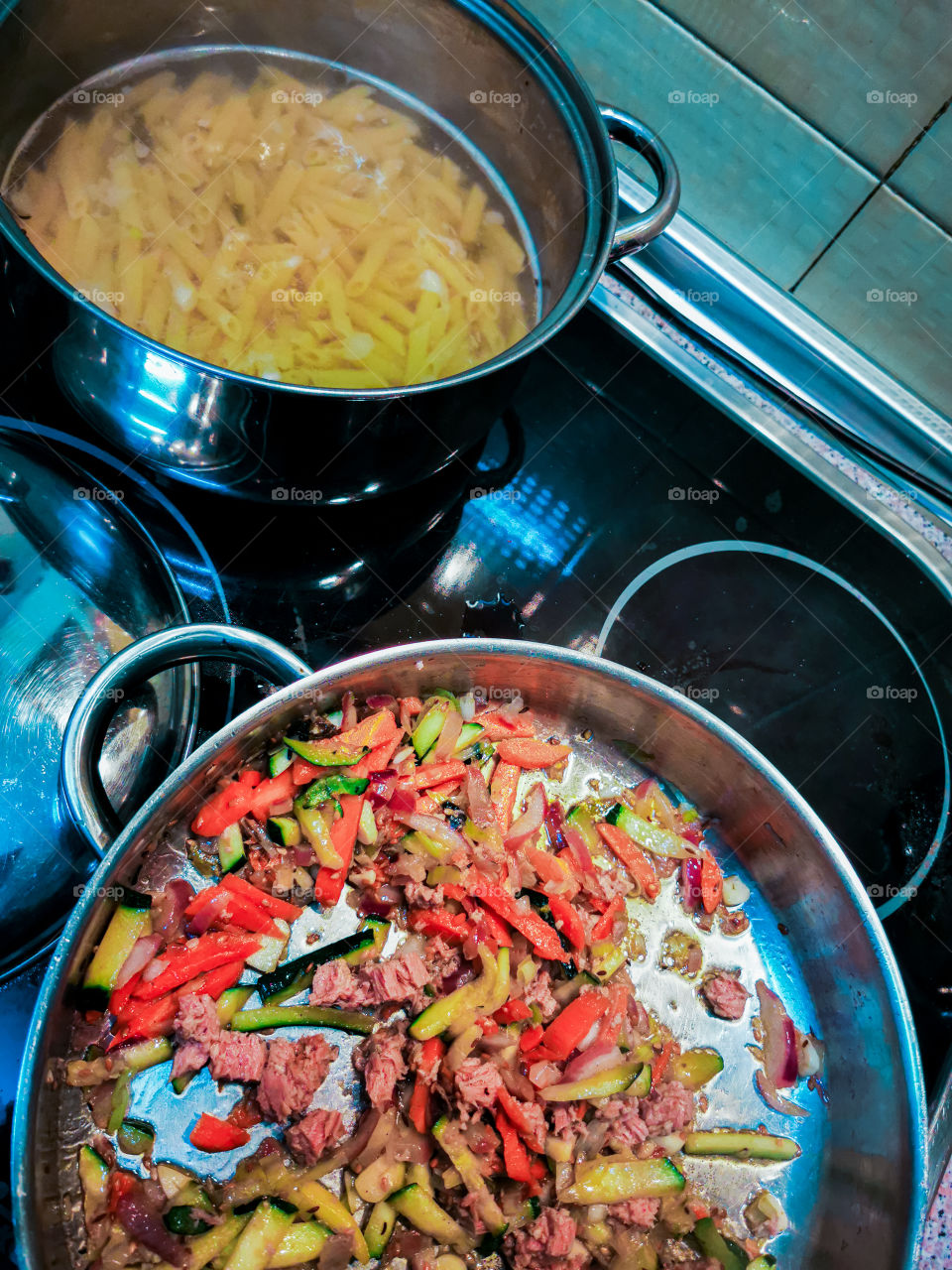Cooking pasta and tuna with vegetables
