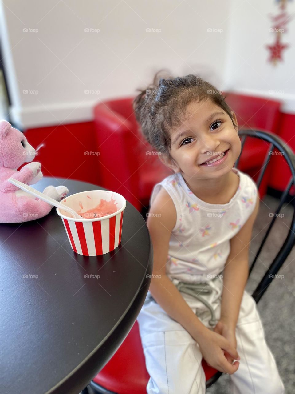 Little girl eats ice cream, getting a treat after Jiu Jitsu class, treats for being good, little girl loves ice cream 