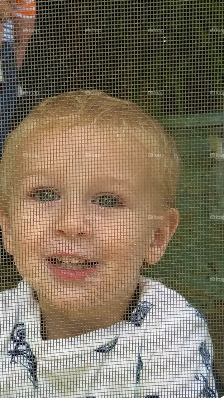 Gradyn through the screen door.