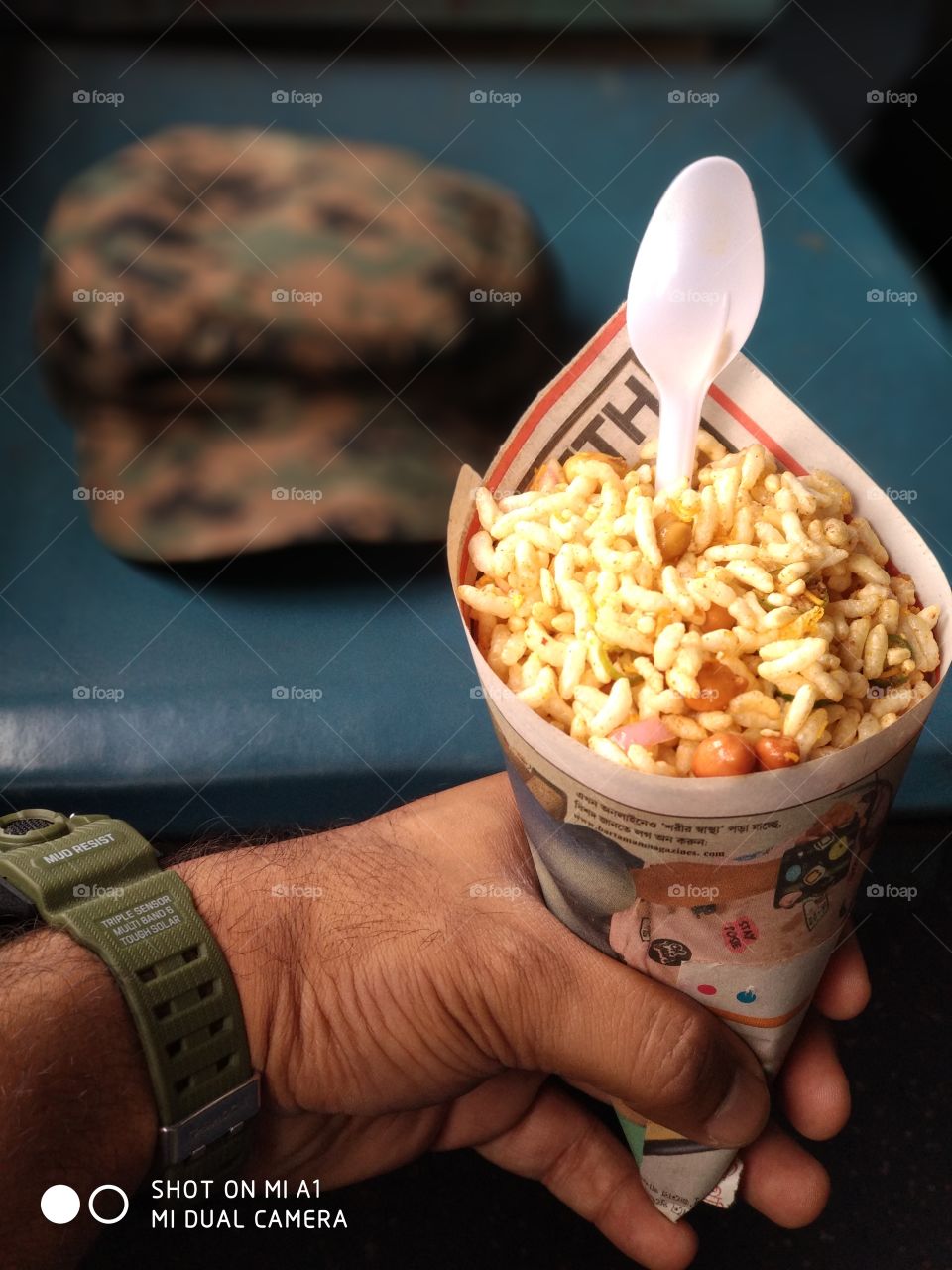 A military man always on duty , enjoying  indian snacks