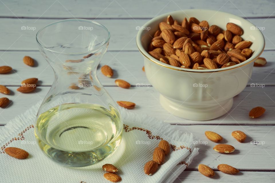 Almonds and almons oil on a wooden table