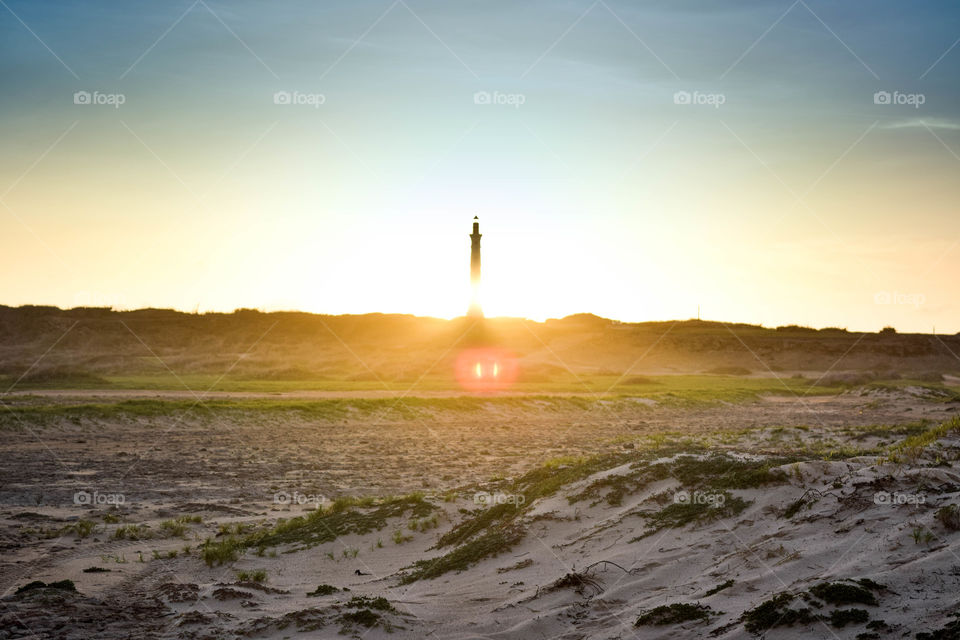 Lighthouse against a sunset with minimal bokeh