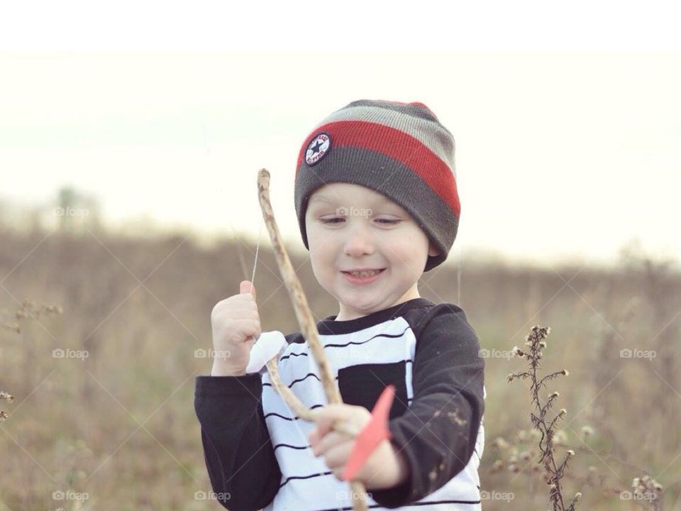 Close-up of a boy playing bow and arrow