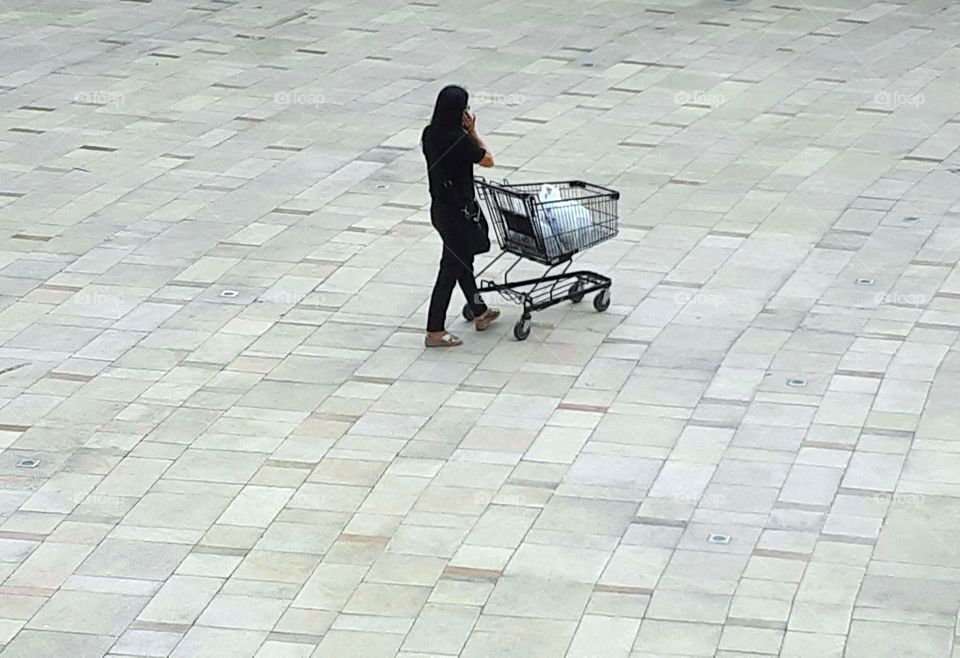 Woman walking with shopping cart