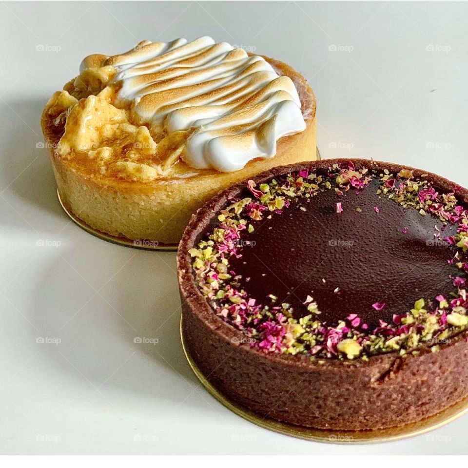 Perfect duo tart in chocolate pistachio rose tart and lemon strawberry meringue tart