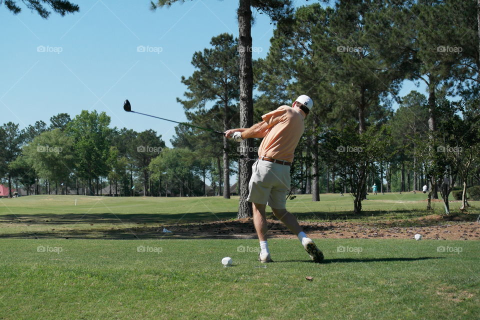 Man playing golf on a golf course