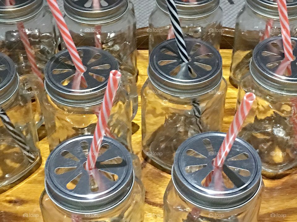 Preparation for a party, mason jar drink mugs and straws 