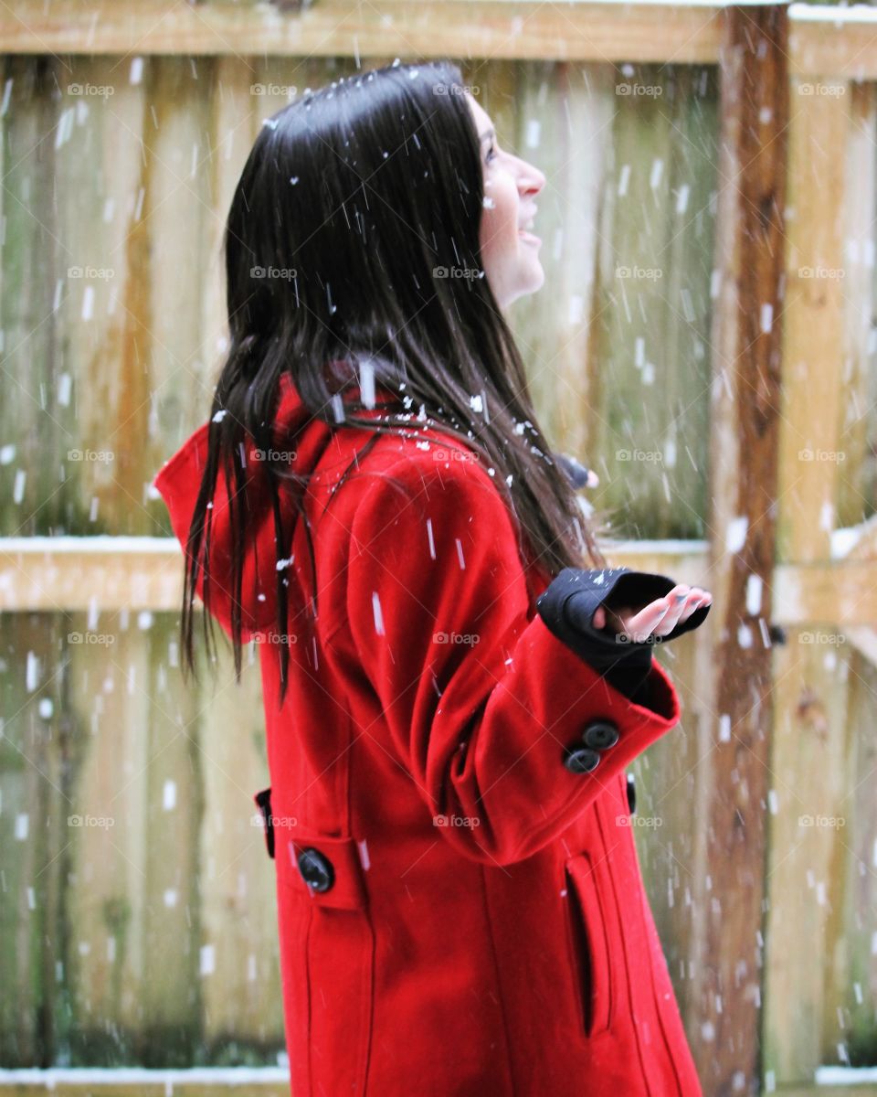 pretty girl in red coat - rare winter snow in the south