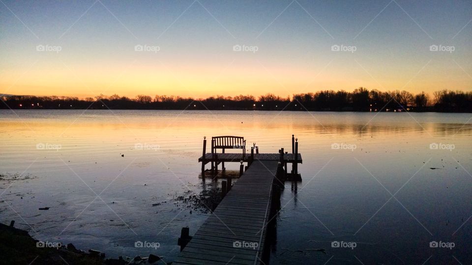 Peaceful tranquility on a quiet lakeside dock at sunrise
